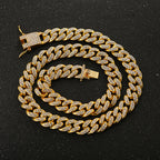 Gold-tone Cuban link chain bracelet featuring embedded sparkling rhinestones and a secure box clasp closure.