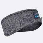 Grey heathered fabric Bluetooth sleep headband with an integrated control panel featuring playback buttons.