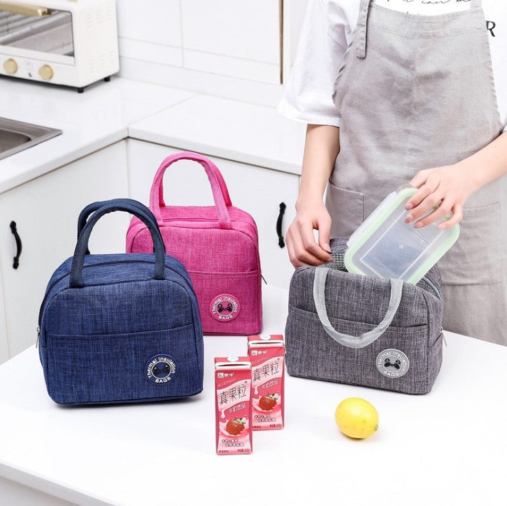 Three portable cationic fabric lunch bags in blue, pink, and grey with thermal lining and carrying handles.