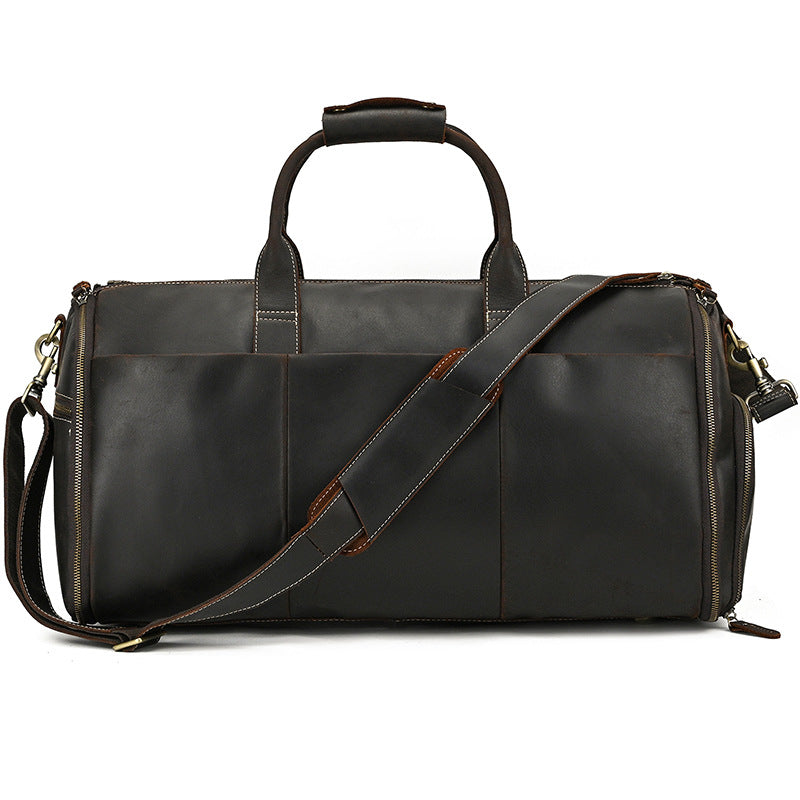 Dark brown vintage-style leather duffle bag with a shoulder strap, carry handles, and side-zippered compartments.