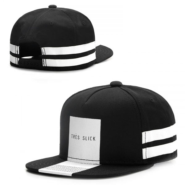 Black hip-hop snapback hat featuring two white horizontal stripes and a central white panel labeled "TRES SLICK."