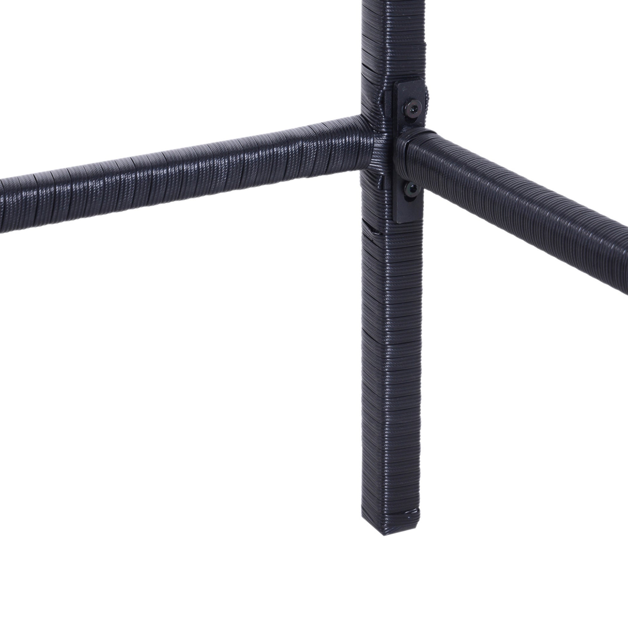 Close-up of black rattan-wrapped metal furniture frame with bolted corner joint.