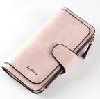 Soft pink suede-feel long wallet by Baellerry, featuring a snap-button closure, zip compartment, and black trim.