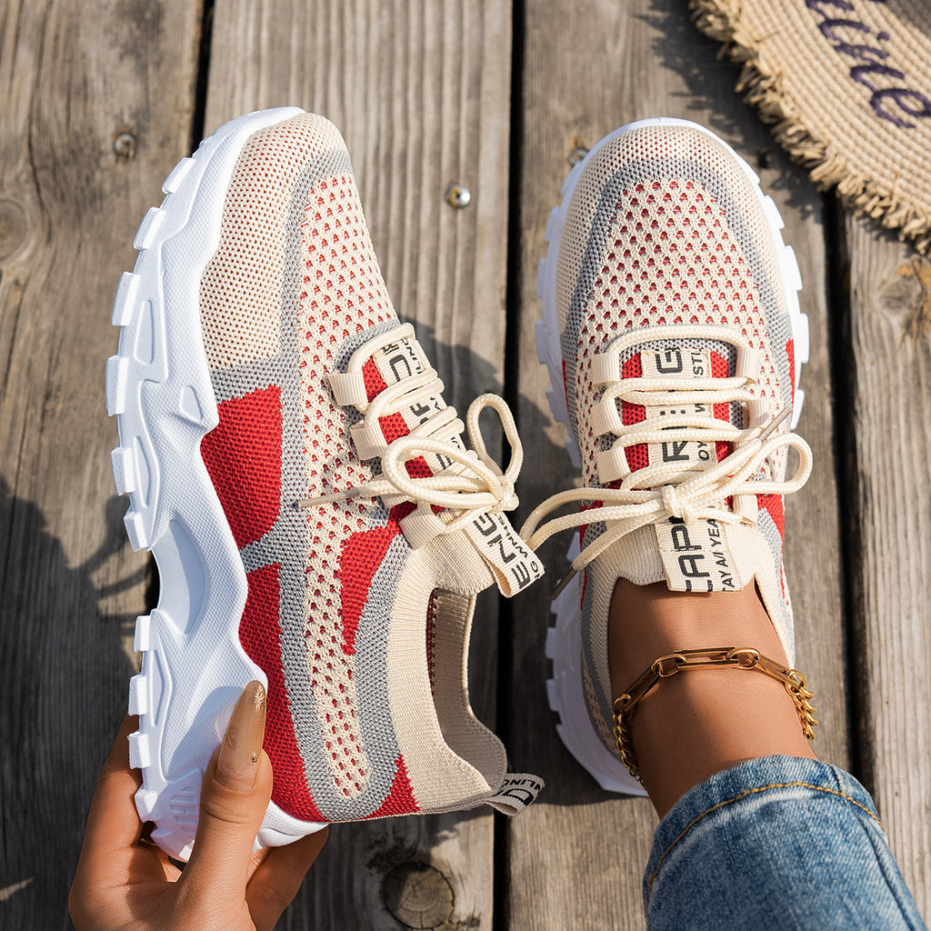 Women’s beige, grey, and red flyknit mesh sneakers with chunky white soles, lace-up fronts, and branded straps.