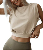 A woman wears a beige, loose-fitting sleeveless crop top with a crew neck and a wide hem band, perfect for fitness.