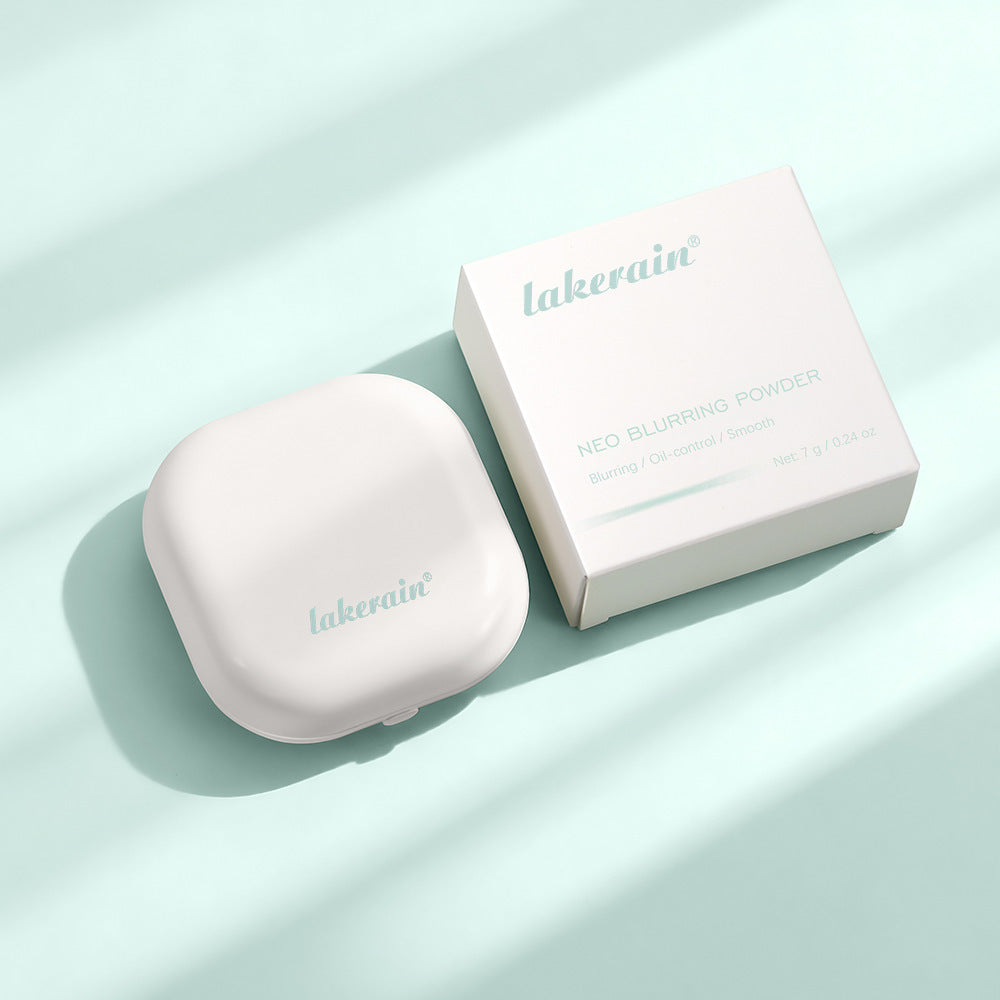 Lakerain Neo Blurring Powder in a white square compact and matching box on a soft mint green background.