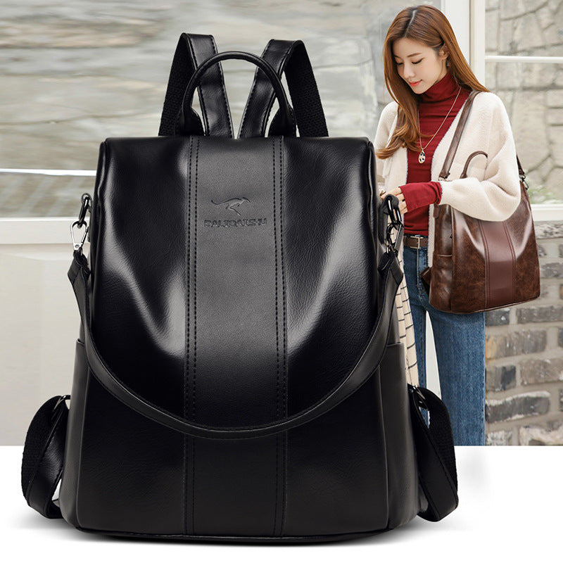 Large black soft leather convertible backpack for women with kangaroo logo, dual straps, and spacious design.