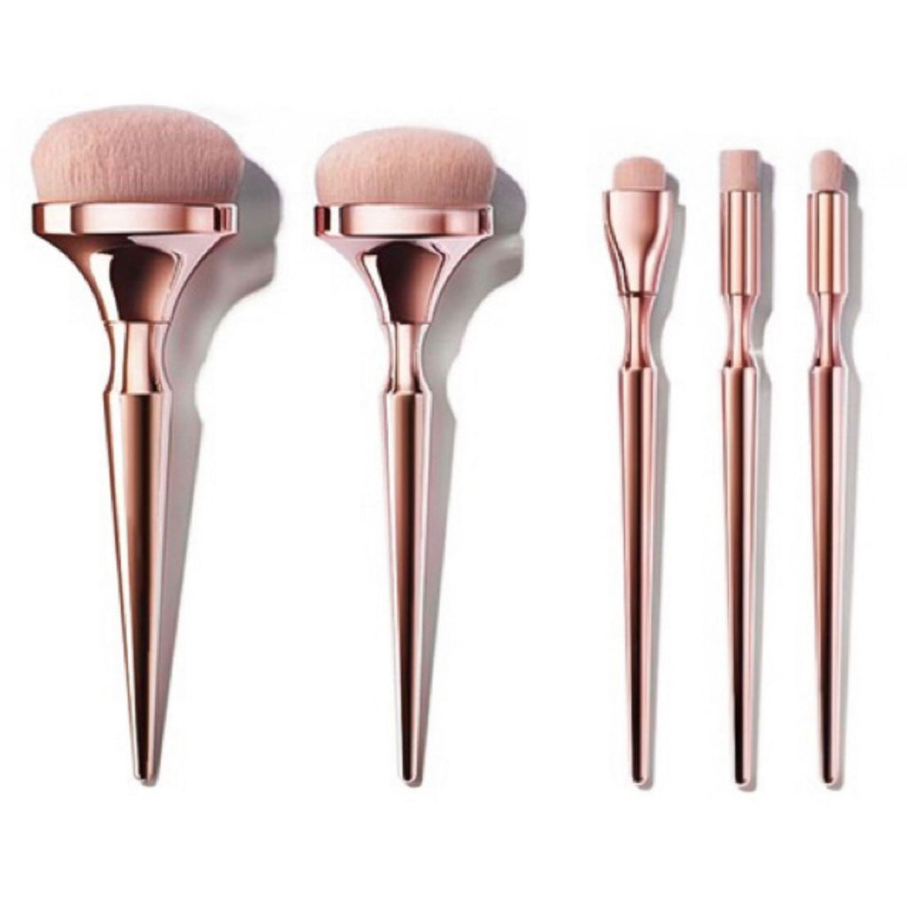 Drunk Gold makeup brush set: five pieces with metallic rose-gold handles and soft, light pink synthetic bristles.