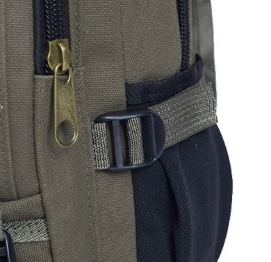 Close-up of an olive green canvas backpack with black accents, a brass-tone zipper, and a black plastic buckle strap.