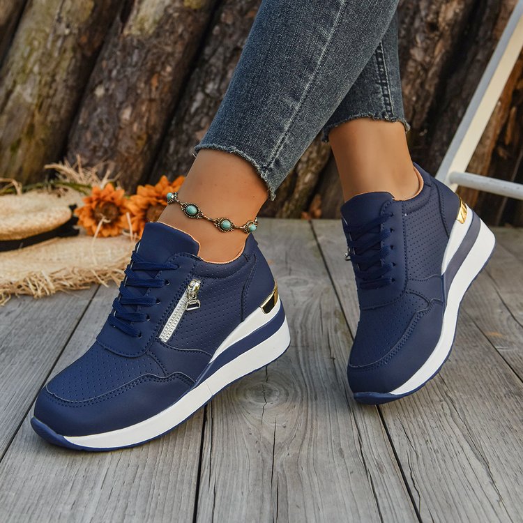Navy blue, perforated lightweight sneakers with lace-up closure, side zipper, and thick white platform wedge soles.