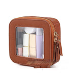 Small brown square PU leather cosmetic bag with a transparent front window, gold zipper, and visible makeup items.