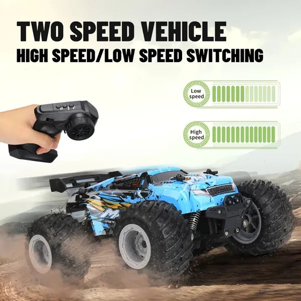 Blue remote-controlled monster truck with large, treaded tires and remote, featuring high and low speed settings.