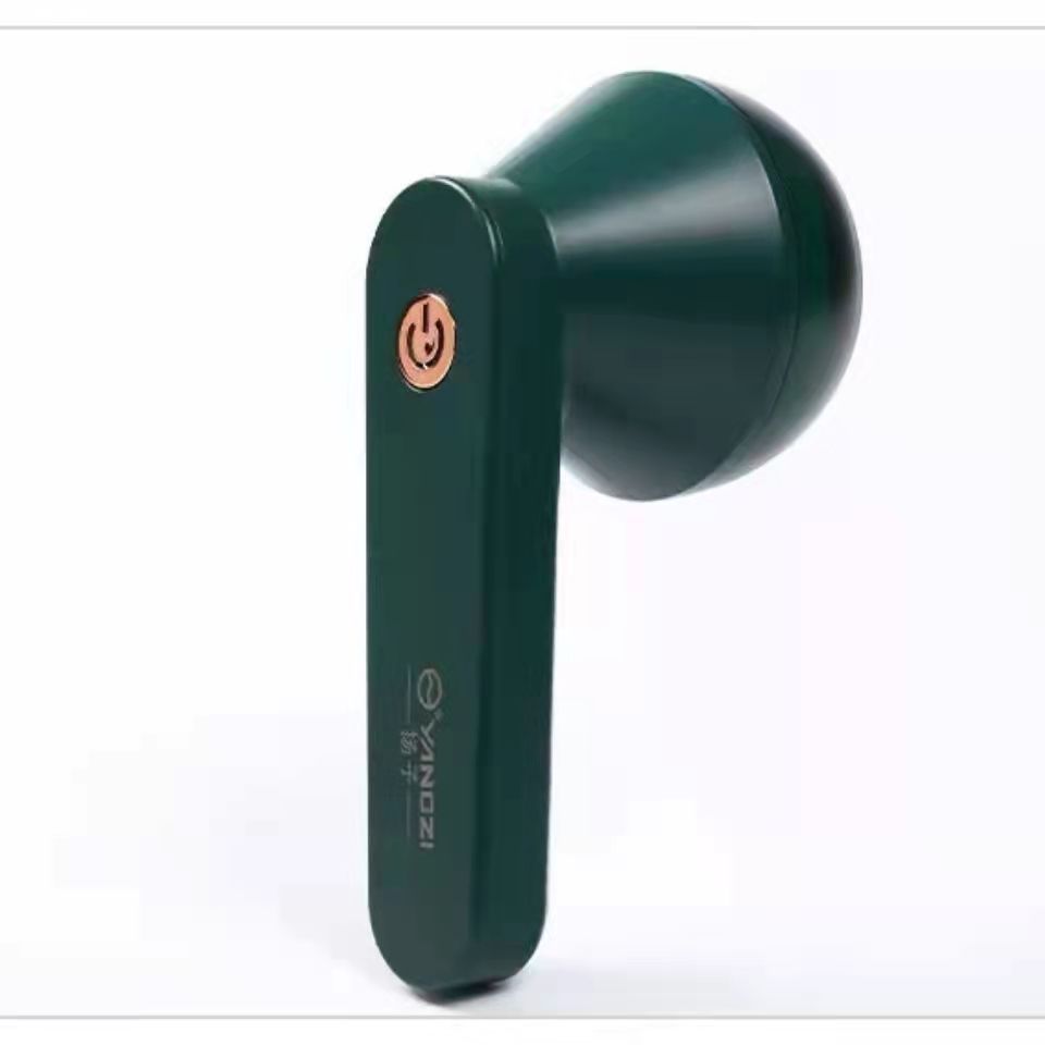 Dark green handheld USB lint remover with a rose gold power button, isolated against a plain white background.