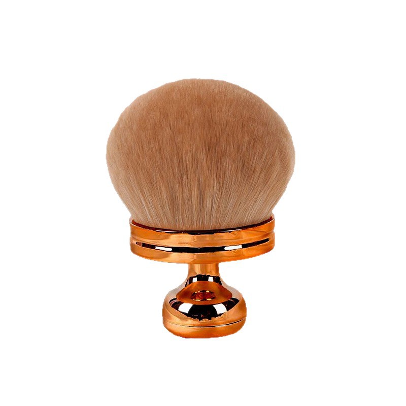 Oversized, soft tan powder brush with a round head and a reflective metallic gold pedestal handle.