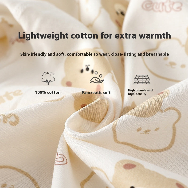 Close-up of soft, cream-colored 100% cotton baby romper fabric with a cute brown bear pattern and text overlays.