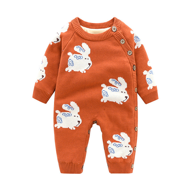 Rust-orange knitted baby romper featuring white rabbit patterns, side button closure, and ribbed cuffs.