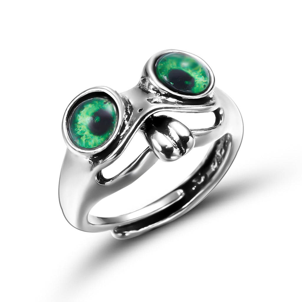 Silver-tone hip hop frog ring featuring two prominent green, realistic glass frog eyes and a cut-out band design.