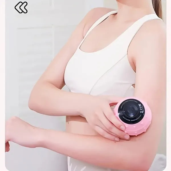 A woman using a pink, textured, rechargeable electric massage ball on her arm for muscle relief.