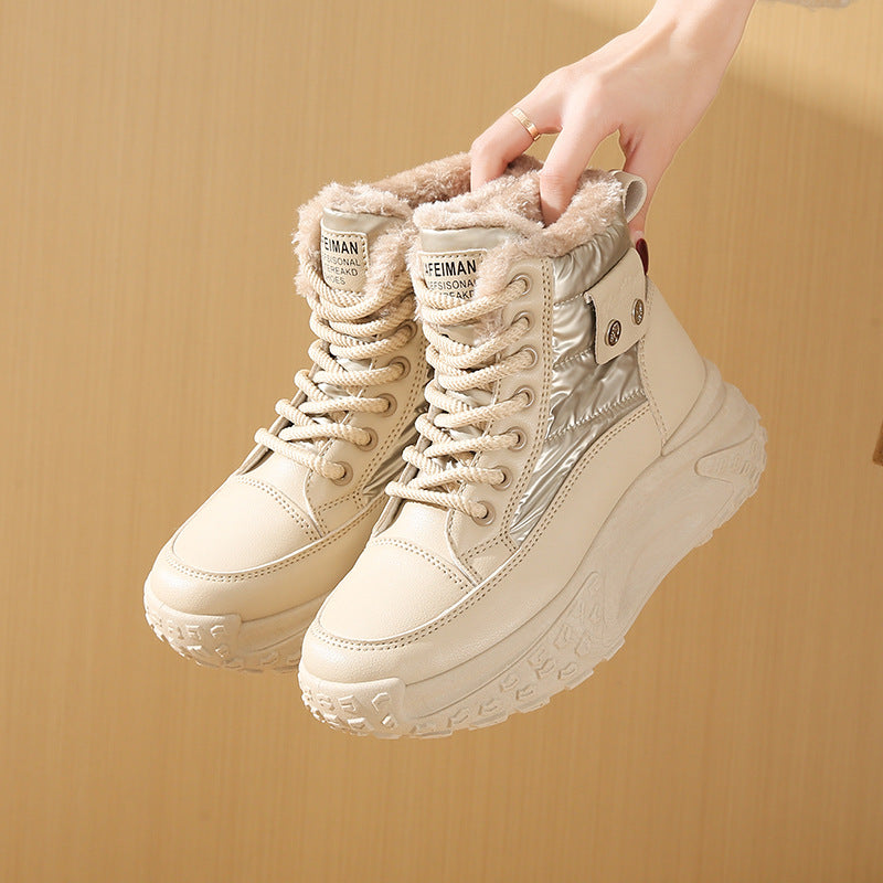 Beige fleece-lined high-top boots with lace-up closure, metallic panels, and chunky, textured platform soles.