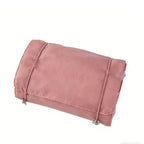 Dusty pink 4-in-1 travel storage bag with a fabric exterior and thin elastic straps, isolated on a white background.
