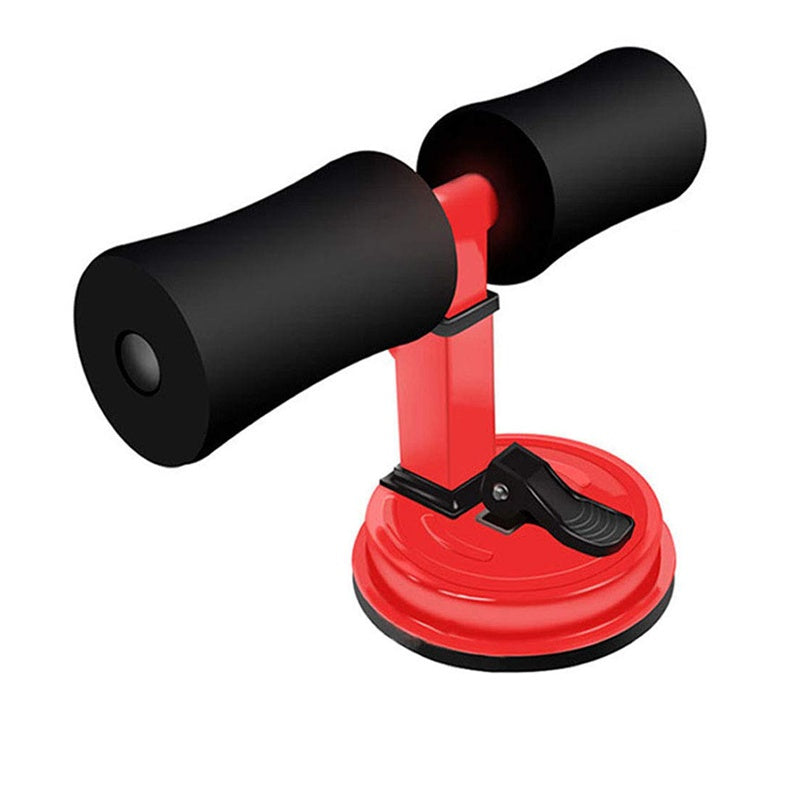 Red and black sit-up bar trainer with foam foot pads, adjustable metal frame, and a suction cup base with a lever.