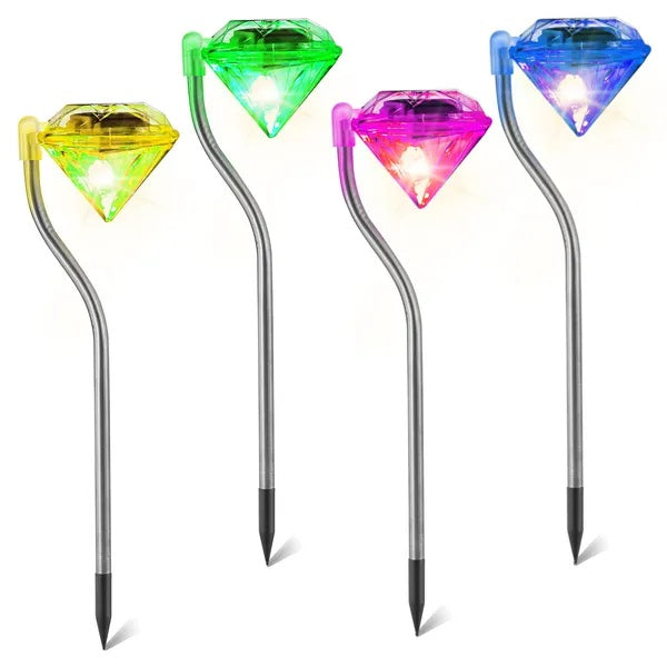 Four colorful, diamond-shaped LED solar garden lights on silver metal stakes with spiked bases.