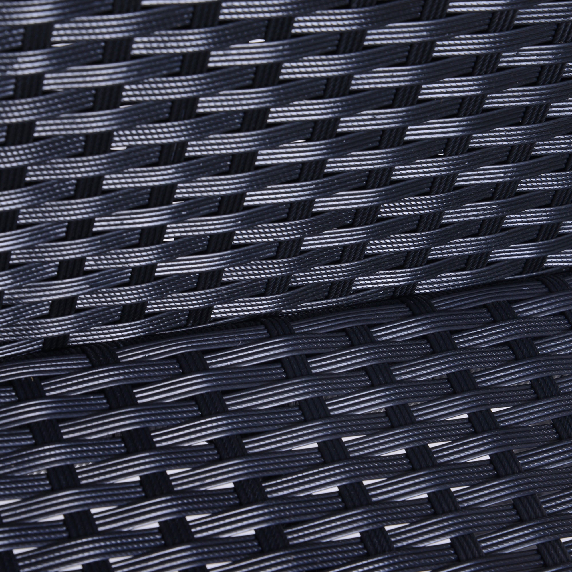 Close-up of black, textured synthetic rattan wicker weave used in outdoor furniture.