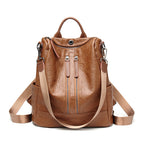 Brown soft leather multifunctional backpack by Digitaldistribution375 with vertical zip pockets and webbing straps.