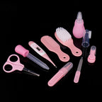 Pink baby health and grooming set includes a digital thermometer, brush, comb, nasal aspirator, scissors, and tools.