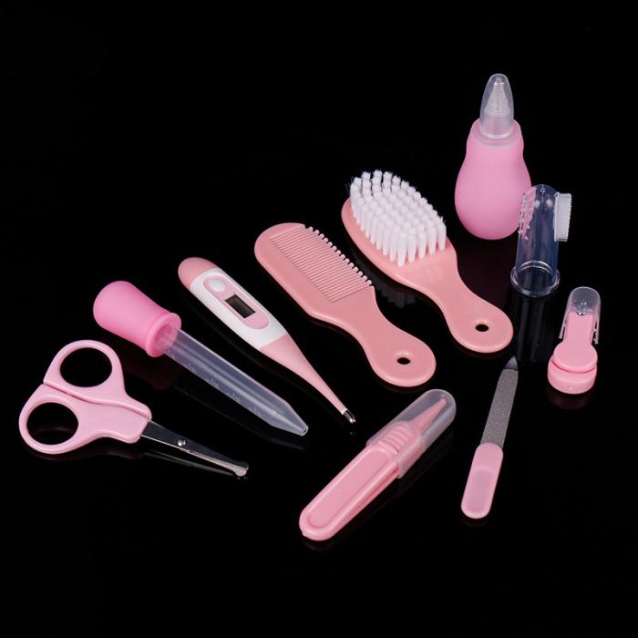 Pink baby health and grooming set includes a digital thermometer, brush, comb, nasal aspirator, scissors, and tools.