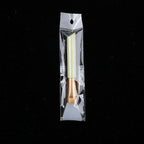 Silicone face mask brush with a pale green handle and gold ferrule, sealed in a clear plastic retail package.
