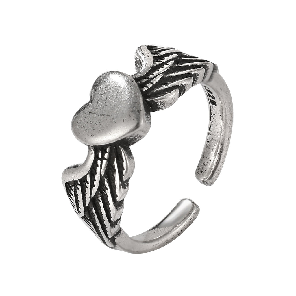Antique silver-tone ring featuring a central heart accented by detailed angel wings on an open-band style.