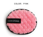 Pink, fuzzy, round makeup cleansing sponge with a black trim and a black "CLEAN SPONGE" label on a white background.