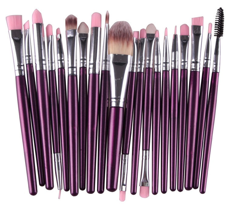 Set of 20 makeup brushes with purple metallic handles, silver ferrules, and soft pink and brown synthetic bristles.