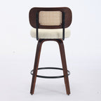 Walnut-finish 26-inch swivel bar stool with a cane backrest, cream upholstered seat, and black metal footrest ring.