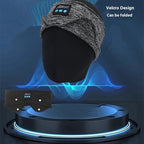 Grey heathered fabric Bluetooth headband on a mannequin head, with a flat view of the black sleep mask version below.