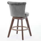 Gray velvet swivel counter stool with tufted back, nailhead trim, and dark wood legs on a white background.