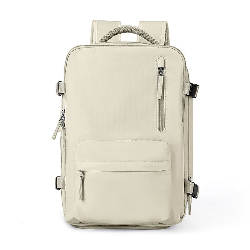 Beige waterproof travel backpack with multiple zippered pockets, adjustable side buckles, and comfortable mesh handle.
