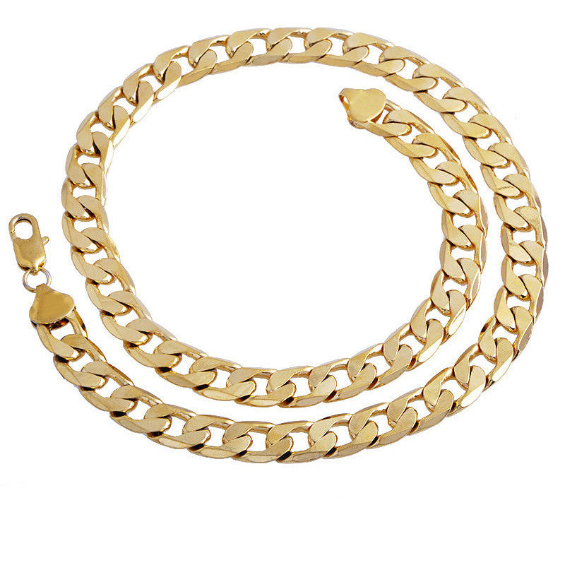 Gold-tone hip hop Cuban link chain necklace with polished finish and lobster claw clasp, isolated on white background.