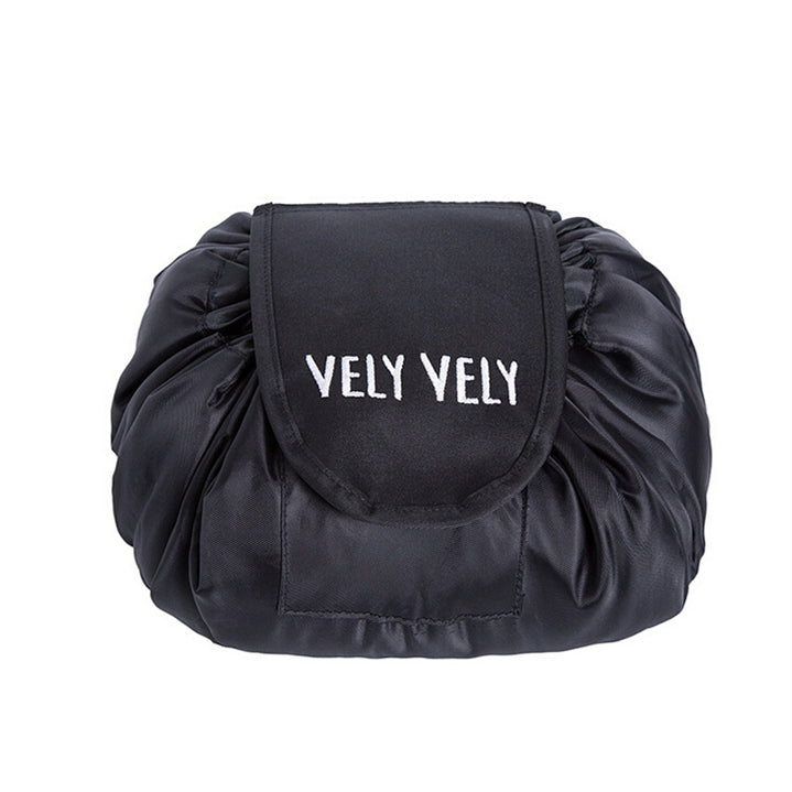 Black satin, drawstring cosmetic bag with a flap featuring white "VELY VELY" embroidery.