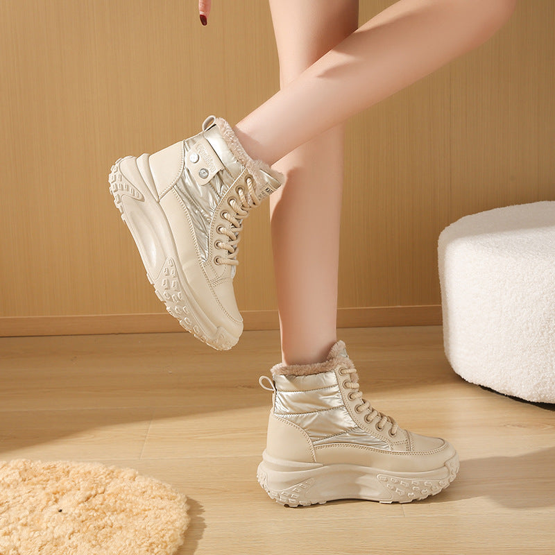 Beige, fleece-lined high-top boots with a metallic quilted finish, lace-up front, and chunky, textured platform soles.
