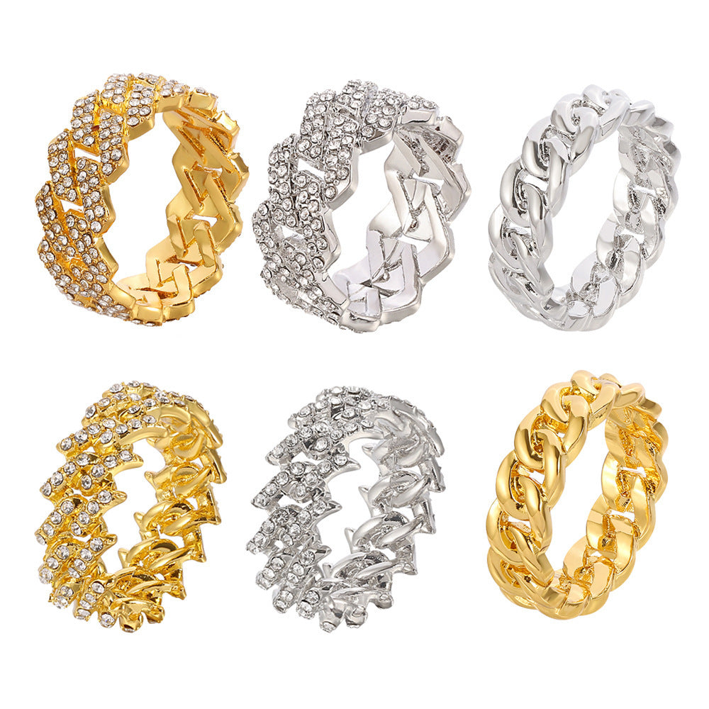Six Cuban-style hip hop rings in gold and silver, some featuring inset rhinestones, displayed against a white background.