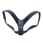 Black medical posture corrector with perforated shoulder straps and a quilted back panel, featuring adjustable buckles.