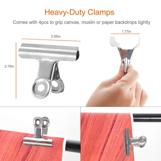 Four metallic silver, heavy-duty spring clamps shown with measurements and in use securing a red wood-grain backdrop.