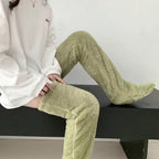 Person wearing sage green, fuzzy, fleece-like over-the-knee leg warmers for cozy indoor warmth.
