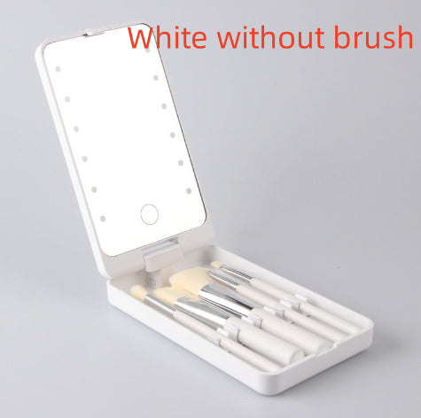 White folding makeup mirror with built-in LED lights and a set of matching white makeup brushes inside a compact case.