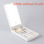 White folding makeup mirror with built-in LED lights and a set of matching white makeup brushes inside a compact case.