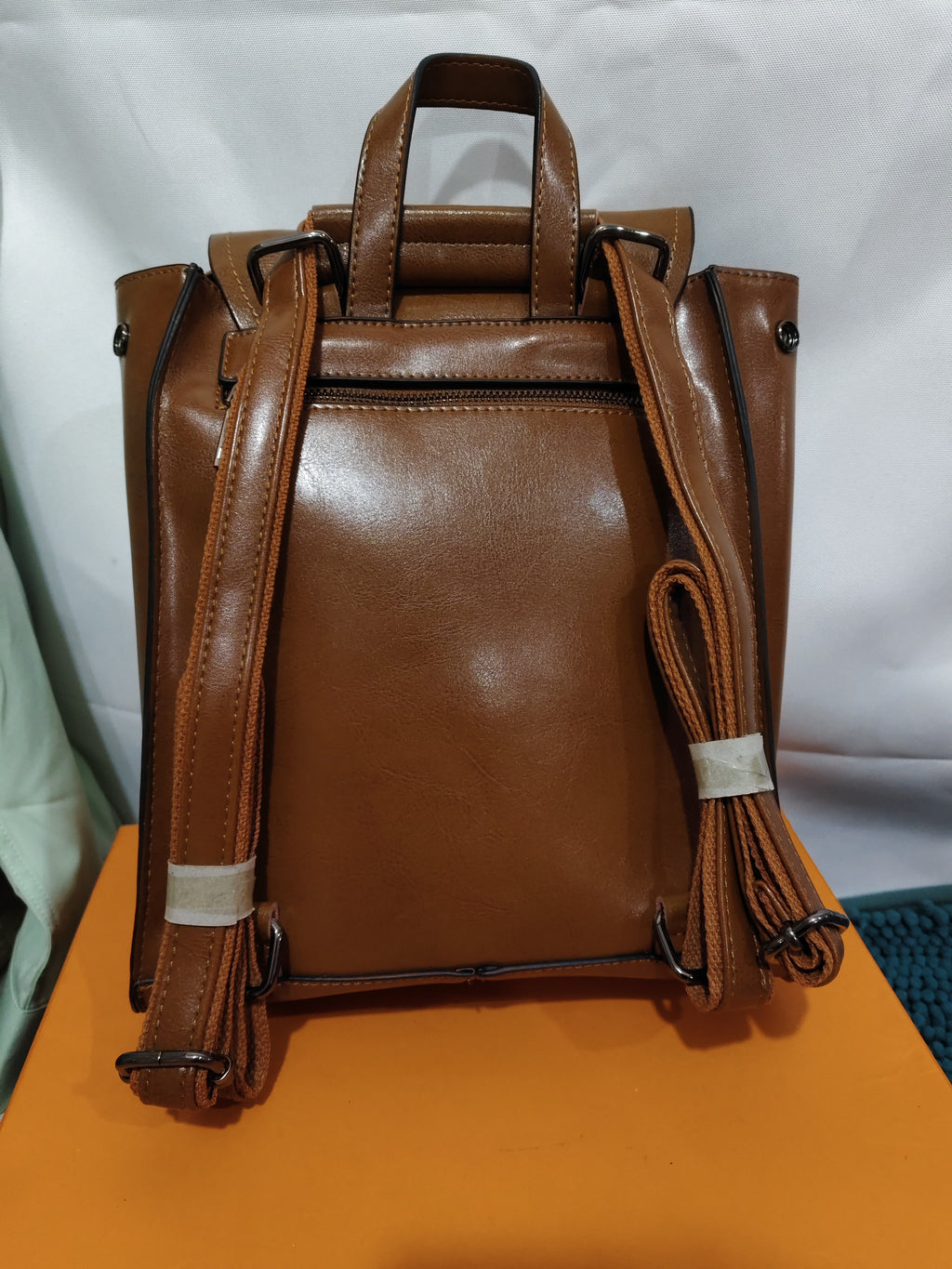 Brown retro genuine leather women's backpack with adjustable shoulder straps and top carry handle.