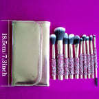 10 makeup brushes with pink diamond-inlaid handles and soft bristles, set with a gold leather case on a purple background.