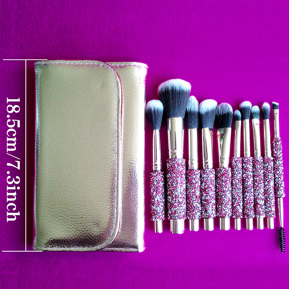 10 makeup brushes with pink diamond-inlaid handles and soft bristles, set with a gold leather case on a purple background.